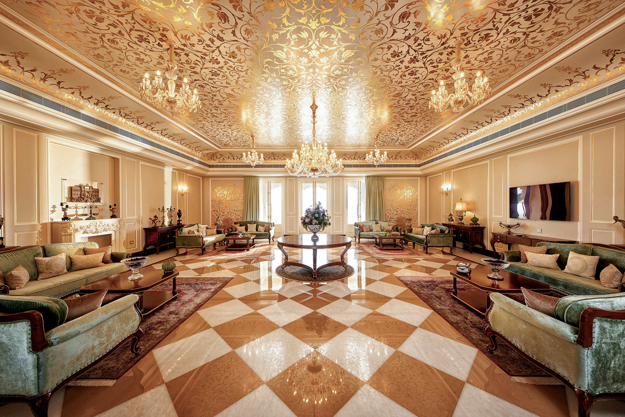 Ornate palace lounge with gilded ceiling and checkered marble floor
